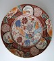 Imari Teller, 
China, 19. 
Jahrhundert. 
Polychrome 
Dekoration mit 
Pfauen neben 
einen 
B&auml;chen. 
...