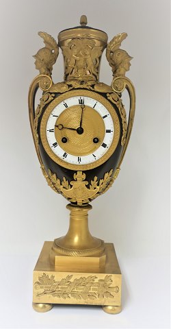 Very well kept French Empire vase shaped mantle clock of gilt and patinated 
bronze. Height 43 cm. Produced approx. 1810th