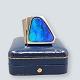 A modern ring 
of 18k white 
gold set with a 
large 
triangular 
opal. 
size 56-57. 
Ring band width 
...