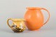 Svend 
Hammershøi 
(1873–1948) for 
Kähler
Two glazed 
ceramic jugs 
with a striking 
orange uranium 
...
