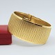Meget bredt 
armbånd  i 18 
kt. guld