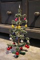 Antique miniature Christmas tree, made of colored paper and decorated with lots of small colored ...